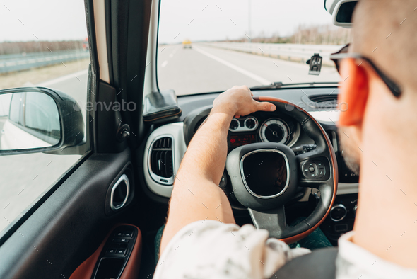 The man in the car traveling on the road Stock Photo by simbiothy | PhotoDune