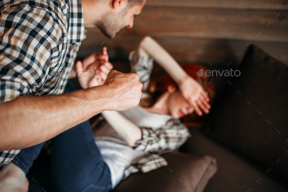 Angry husband beats his wife, domestic violence Stock Photo by NomadSoul1