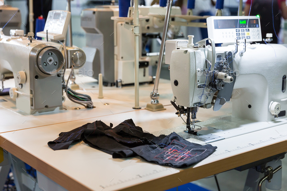 Sewing machine and cloth in cutting shop, nobody Stock Photo by NomadSoul1