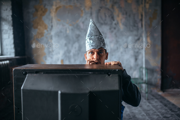 Afraid man in aluminum foil cap watch TV, UFO Stock Photo by NomadSoul1