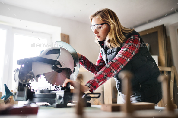 young woman worker in the carpenter workroom stock photo by halfpoint worker stock