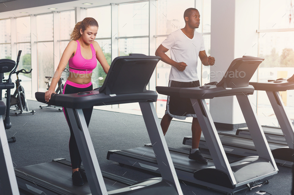 Man and woman, couple in gym on treadmills Stock Photo by Milkosx | PhotoDune