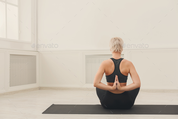 Young woman in yoga class, Reverse Prayer Pose Stock Photo by Milkosx