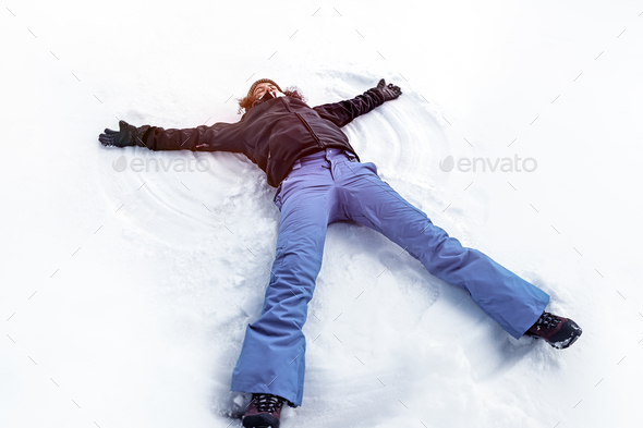 Young female making snow angel Stock Photo by Anna_Om | PhotoDune