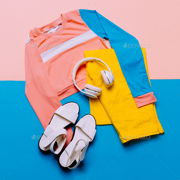 Stylish sports blouse and pants. Pastel trend. Sandals, earphone Stock Photo by EvgeniyaPorechenskaya