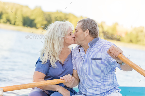 Elderly couple kissing on a boat Stock Photo by photocreo | PhotoDune