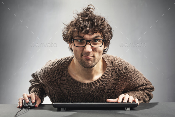 Young man playing game on a computer. Stock Photo by photocreo | PhotoDune