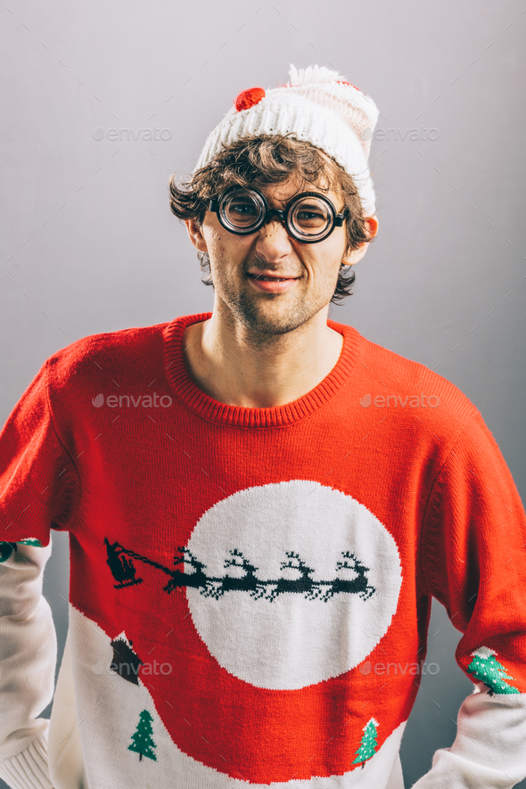 Grumpy man in funny christmas clothes and glasses. Stock Photo by photocreo