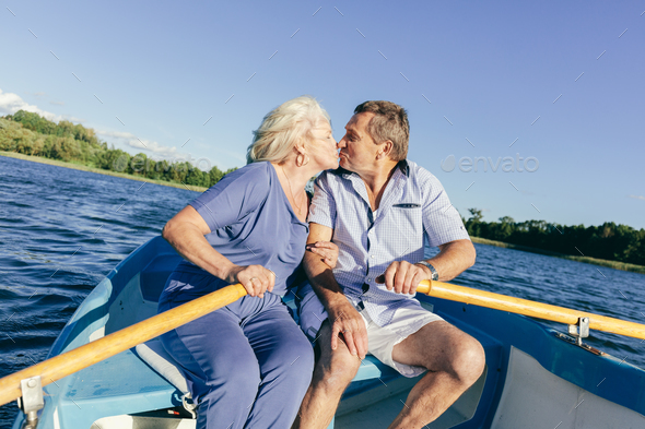 Senior couple kissing on a boat Stock Photo by photocreo | PhotoDune