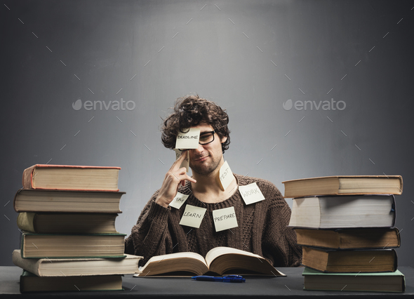 Man covered in sticky notes, studying. Stock Photo by photocreo | PhotoDune