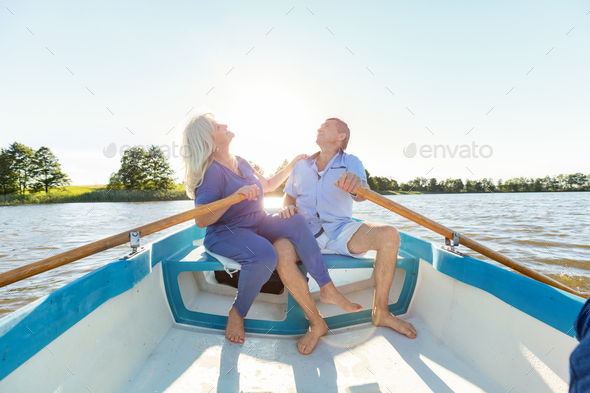 Older couple swimming in a boat Stock Photo by photocreo | PhotoDune