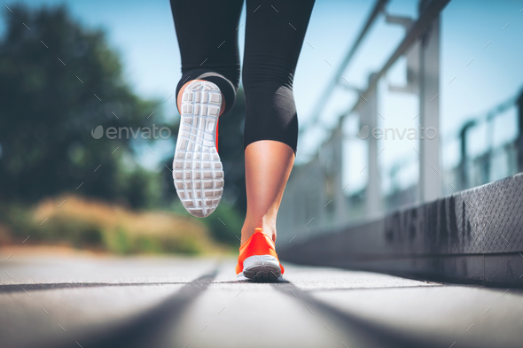 City workout. Woman running in an urban setting Stock Photo by tommyandone