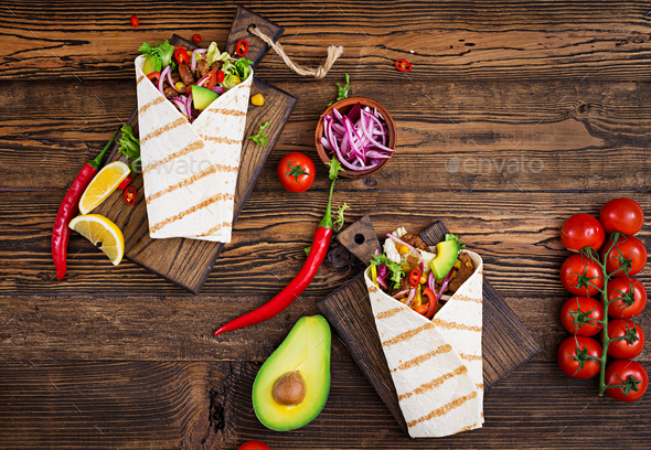 Mexican tacos with beef in tomato sauce and avocado salsa. Flat lay. Top view Stock Photo by Timolina