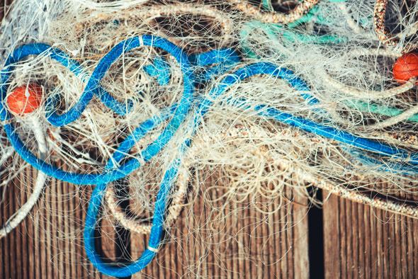 Pile of commercial fishing net with cords and floats Stock Photo by stevanovicigor