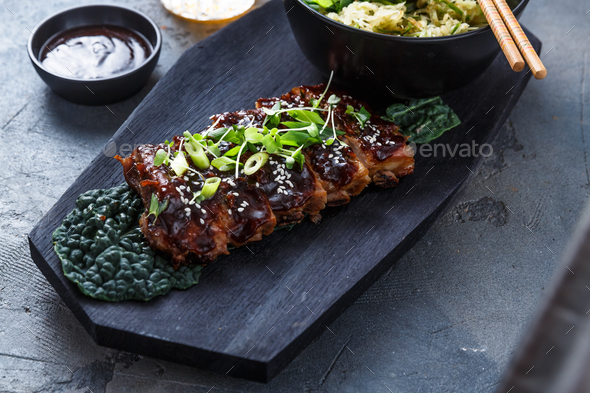 Asian style Barbecue pork ribs honey glazed on wooden board, top view Stock Photo by fazeful
