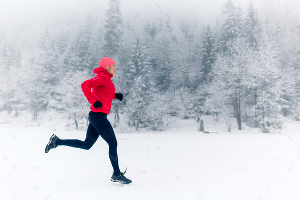 Girl running on snow in winter mountains Stock Photo by blas | PhotoDune