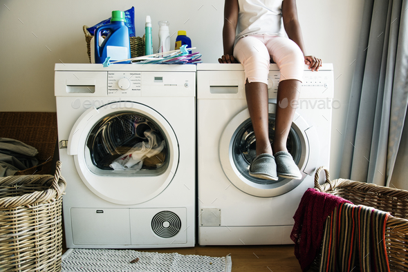 Young teen girl waiting for clothe to be washed from washing machine Stock Photo by Rawpixel