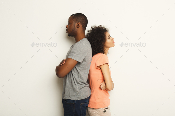 Break up, upset couple back to back after quarrel Stock Photo by Milkosx