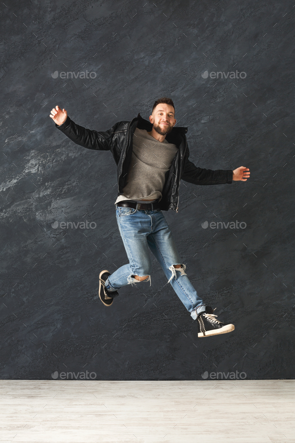 Happy handsome man jumping in studio Stock Photo by Milkosx | PhotoDune