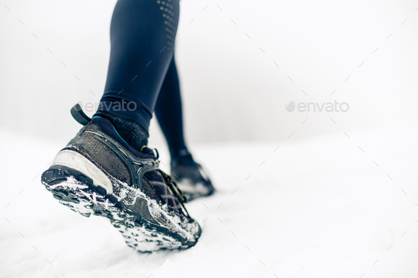 Hiking or walking shoes on snow, winter mountains Stock Photo by blas