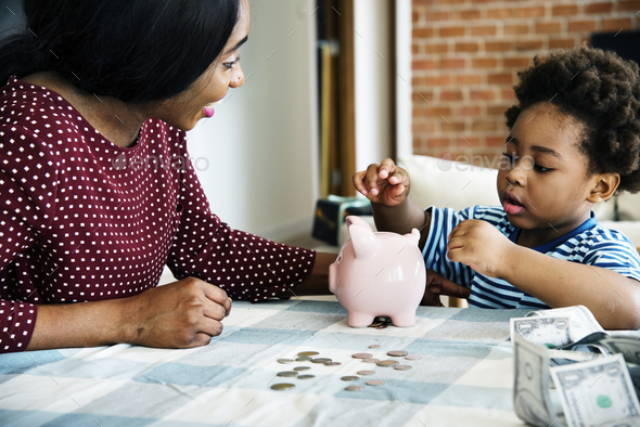 Mom and son saving money to piggy bank Stock Photo by Rawpixel | PhotoDune