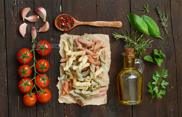 Tricolor pasta, vegetables, herbs and olive oil Stock Photo by katrinshine
