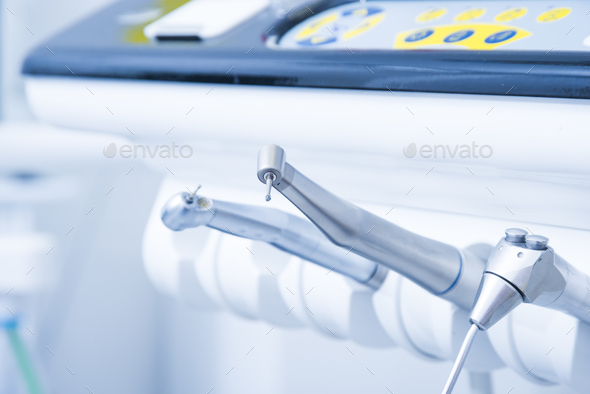 Dentist instruments. Dental diamond cylinder bur with hand-piece. Blurred dental office background Stock Photo by gargantiopa