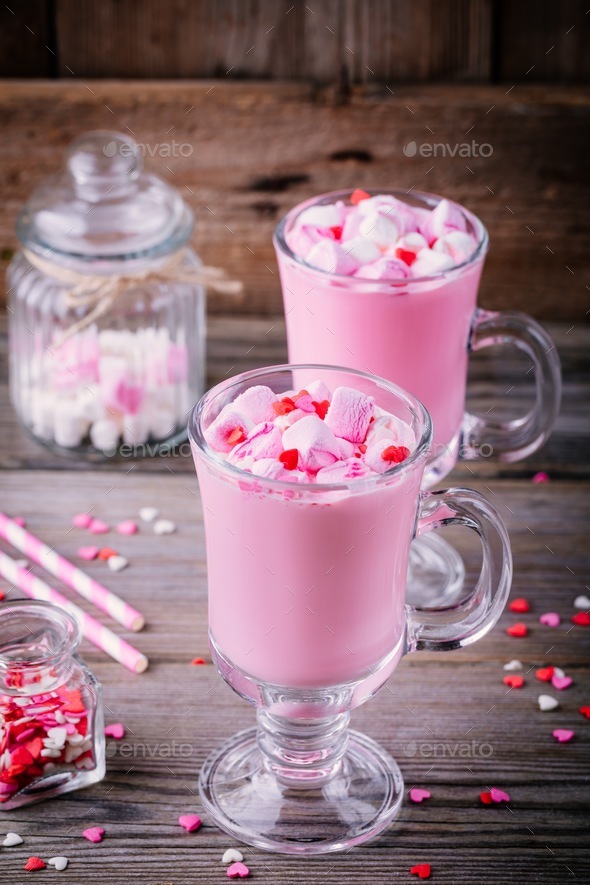 Pink hot chocolate with marshmallow and sugar hearts in a glass mug for Valentine Day Stock Photo by nblxer