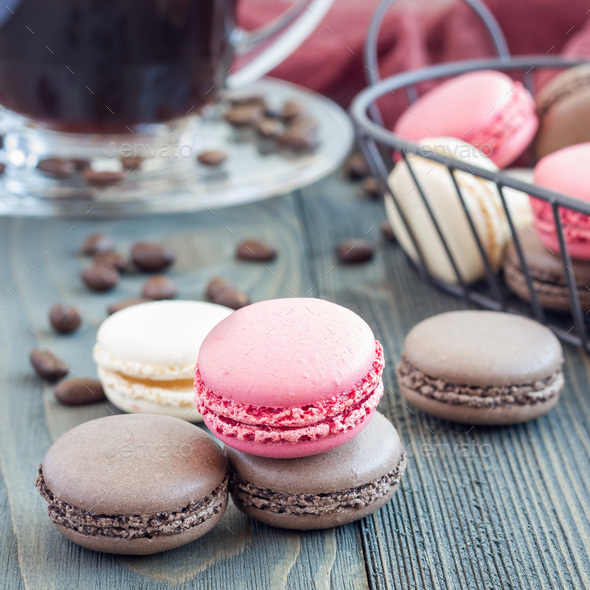 Different kinds of colorful french dessert macaron, served with coffee, square Stock Photo by iuliia_n
