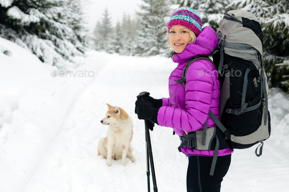 Happy woman walking in winter forest with dog Stock Photo by blas | PhotoDune