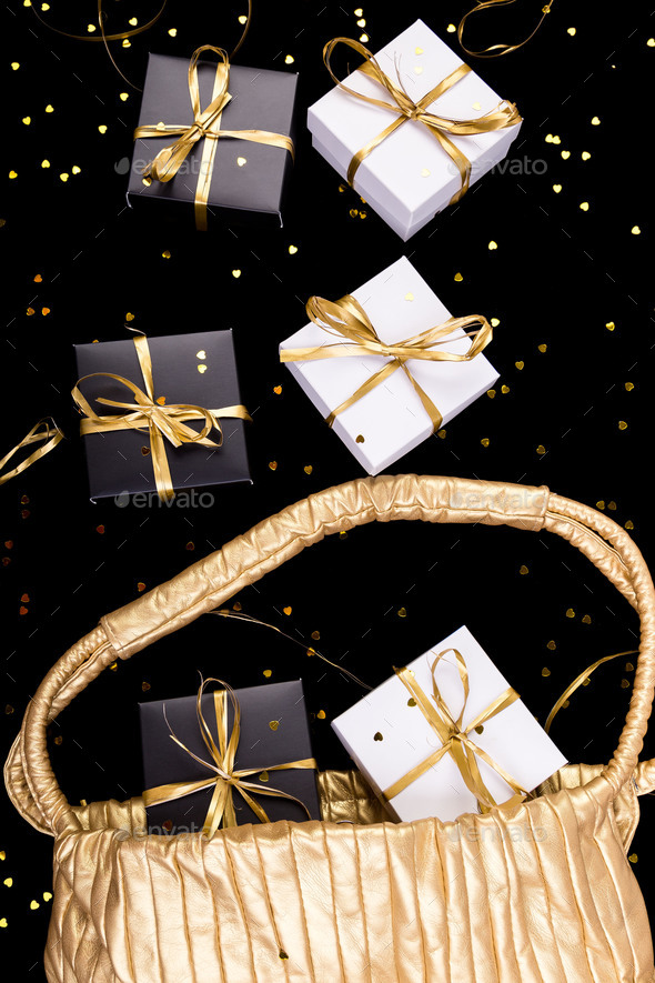 Black and white gift boxes with gold ribbon Stock Photo by bondarillia