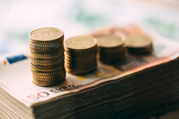Euro coins on cash stack closeup Stock Photo by ivankmit | PhotoDune