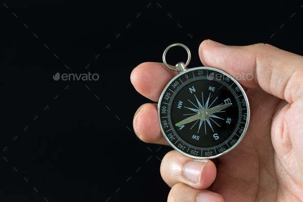 Compass in hand Stock Photo by kenishirotie | PhotoDune