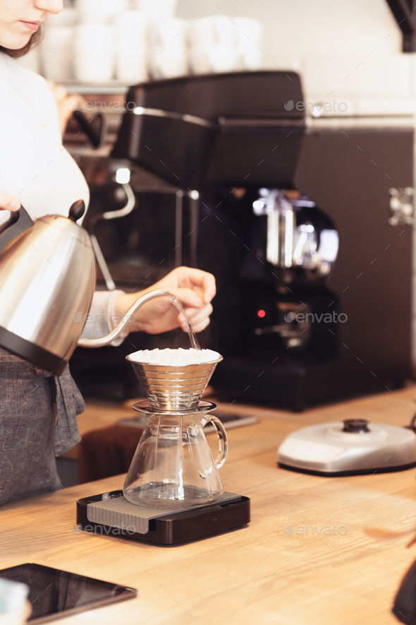 Hand drip coffee, Barista pouring water on coffee ground with filter Stock Photo by master1305