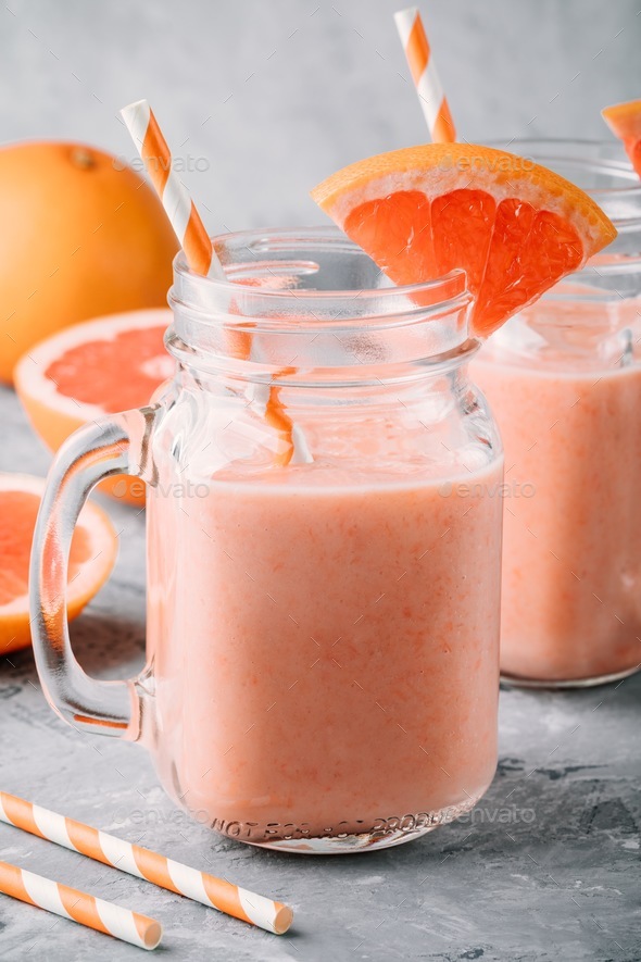 healthy detox smoothie in mason jar of red grapefruit with banana and chia seeds Stock Photo by nblxer