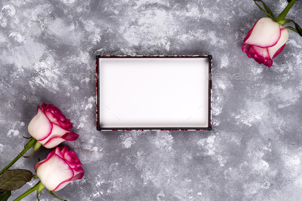Floral frame: bouquet of pink white roses on stone background with copy space for text. Stock Photo by lyulkamazur