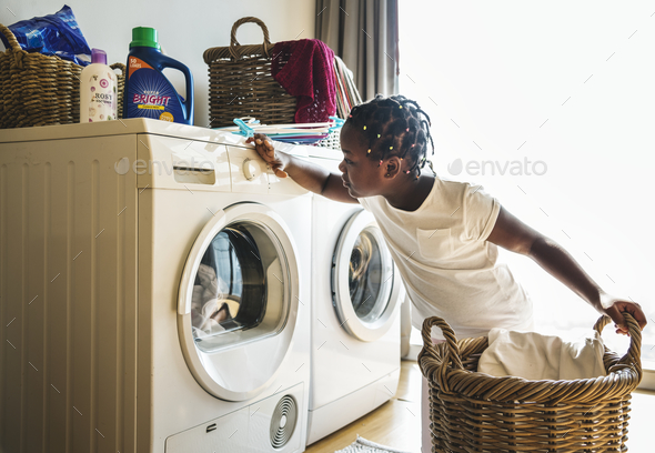 Young teen girl washing clothes using washing machine Stock Photo by Rawpixel