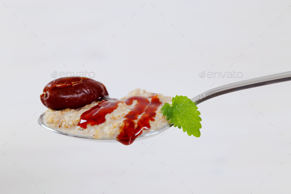 spoon of oatmeal porridge with dates Stock Photo by Vikif | PhotoDune