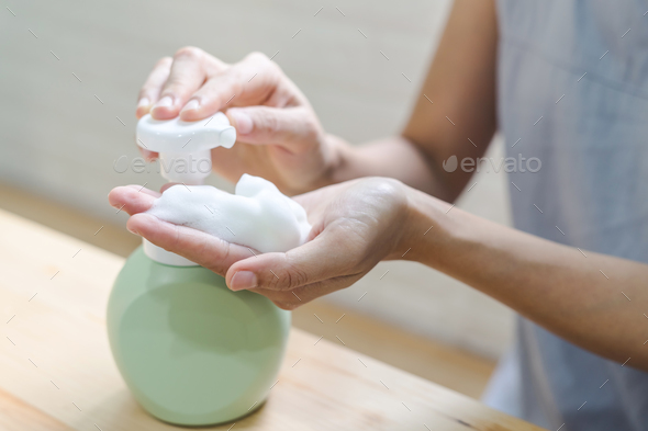 Close up of woman hand take cleaner foam Stock Photo by kitzstocker
