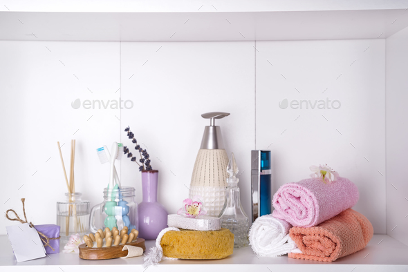Various spa and beauty threatment products on white shelf Stock Photo by lyulkamazur