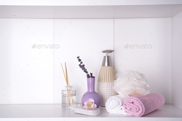 Various spa and beauty threatment products on white shelf Stock Photo by lyulkamazur