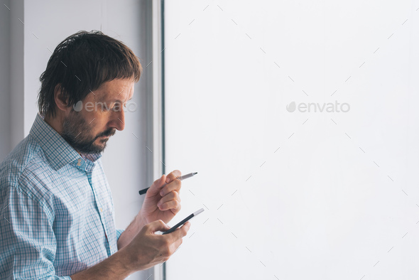 Businessman in office writing on whiteboard Stock Photo by stevanovicigor