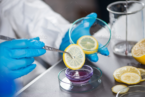 Food safety inspector testing fruit from the market Stock Photo by microgen