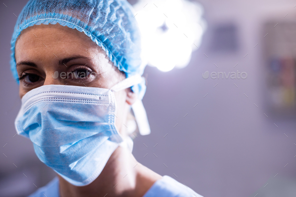 Portrait Of Female Nurse Wearing Surgical Mask In Operation Theater