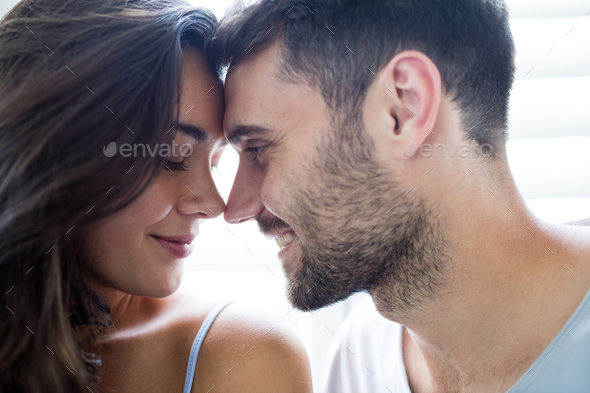 young couple romancing in bedroom stock photo by wavebreakmedia