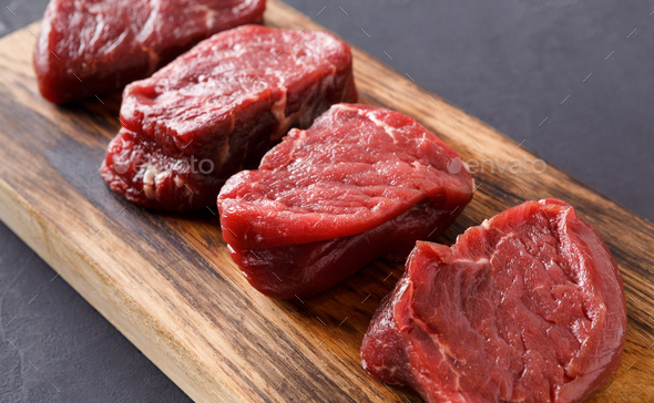 Raw Beef Filet Mignon Steaks On Wooden Board At Gray Background Stock