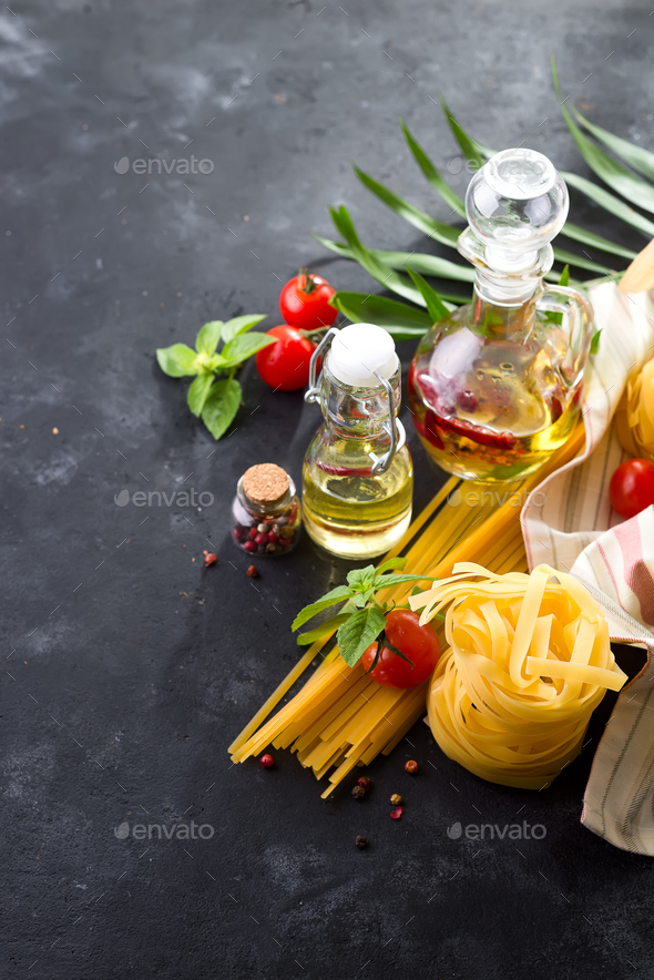 Food ingredients for Italian spaghetti on black stone slate background with palm leave Stock Photo by lyulkamazur