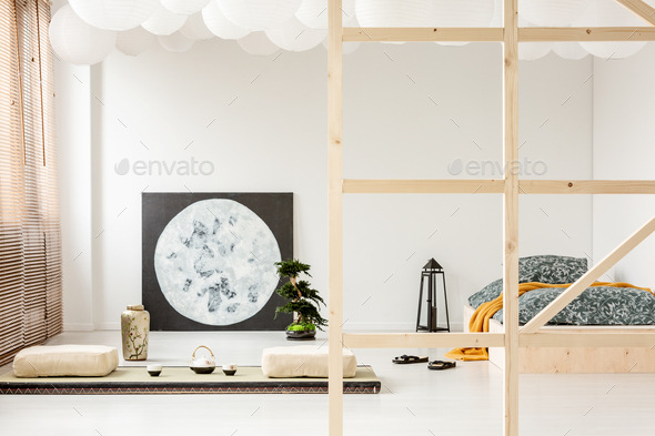 Pillows on the floor and moon poster in bedroom interior with la Stock Photo by bialasiewicz