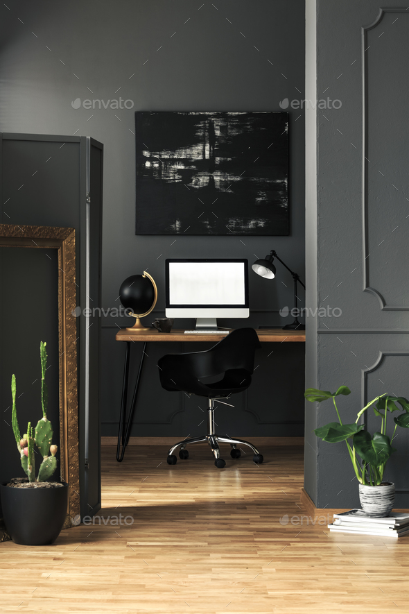 Dark living room interior with molding on walls in real photo wi Stock Photo by bialasiewicz