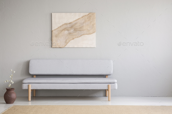 Painting above grey settee in minimal living room interior with Stock Photo by bialasiewicz